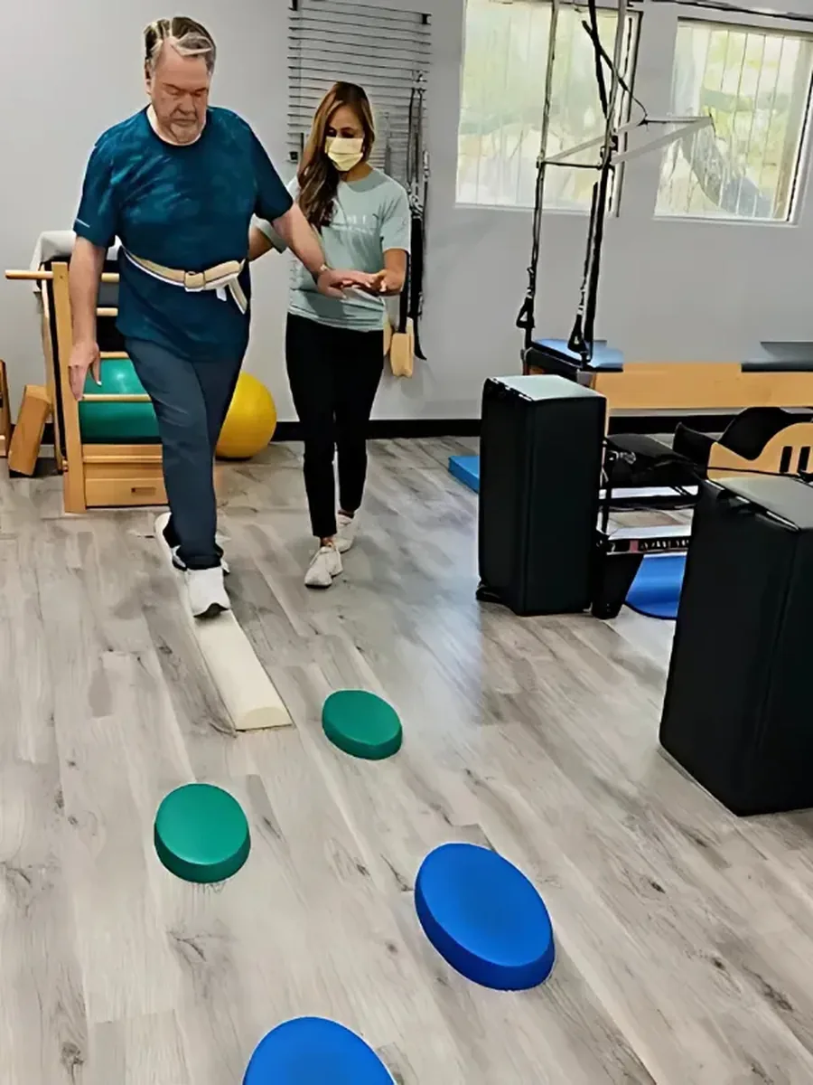 A physical therapist assessing how a patient moves at Pyramid Physical Therapy & Pilates in San Antonio, TX