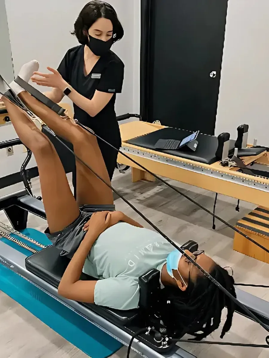 A patient building strength with Pilates-based rehab at Pyramid Physical Therapy & Pilates