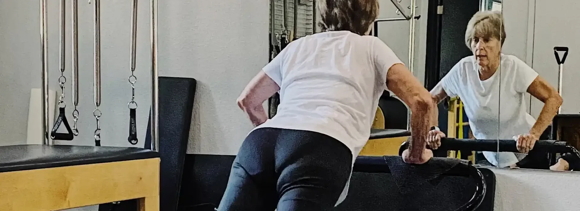 Patient working on Pilates reformer equipment at Pyramid Physical Therapy & Pilates in San Antonio