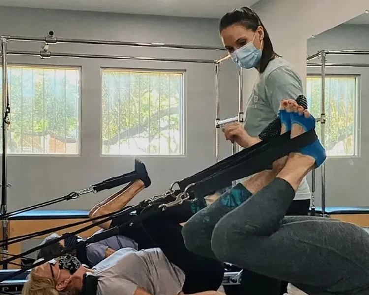 Instructor guiding patients through reformer exercises at Pyramid Physical Therapy & Pilates in San Antonio, TX